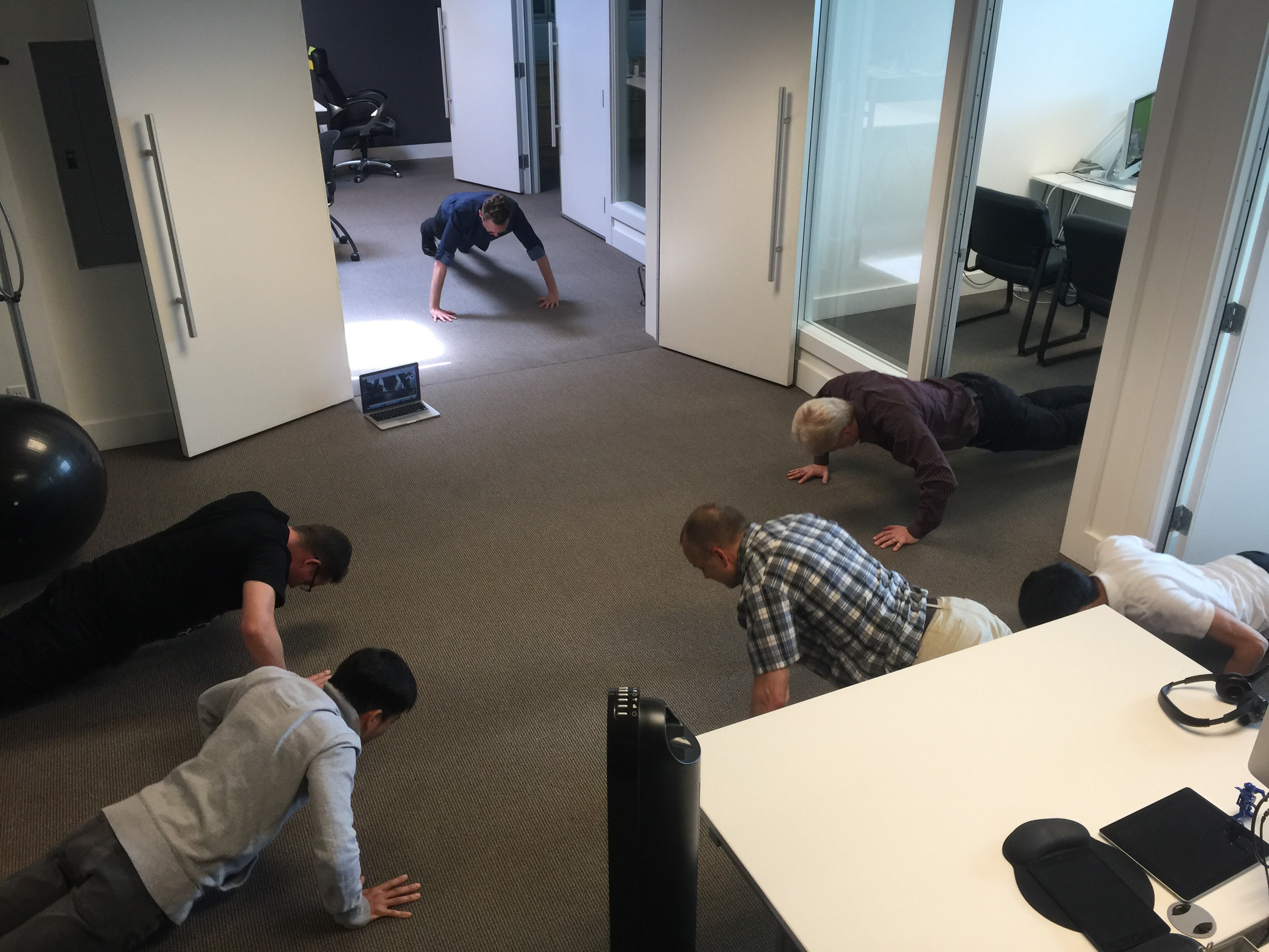A remotee joining our weekly #toughcoders push-up challenge by webcam, via Google Meet.