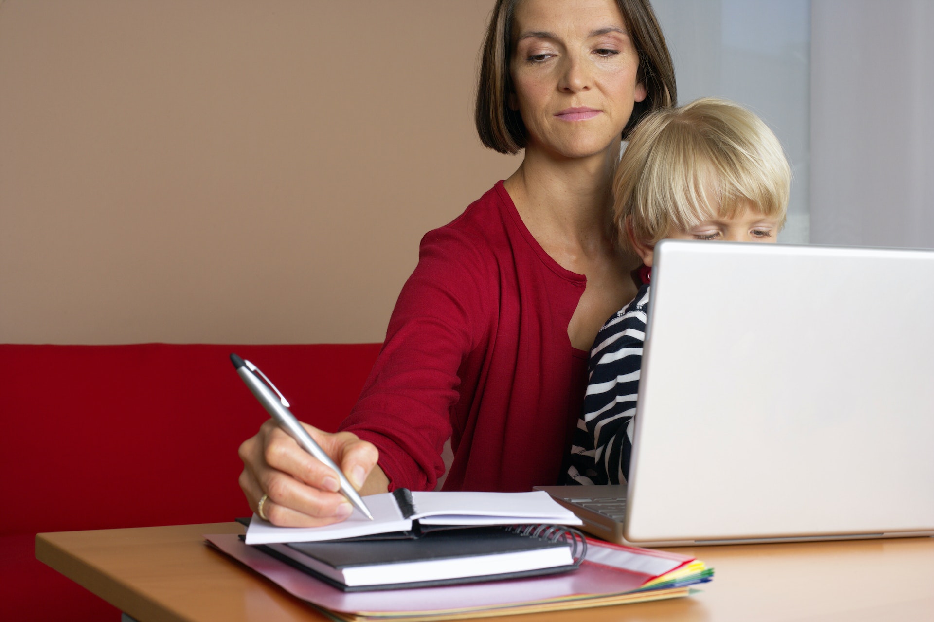 Mother with child studying on laptop