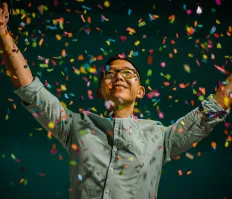 man celebrating in confetti