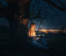 Person reading glowing book