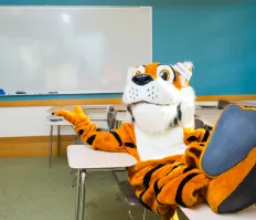 Trinity tiger mascot sitting in classroom