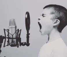 A boy speaking at the microfone