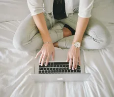 A person typing on her laptop