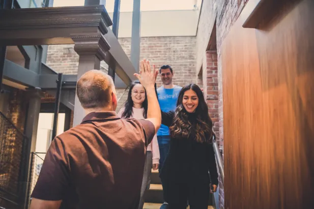 Team members high five in celebration