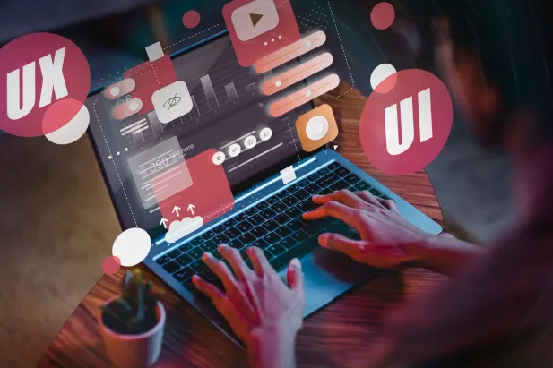 Person typing on laptop with floating icons