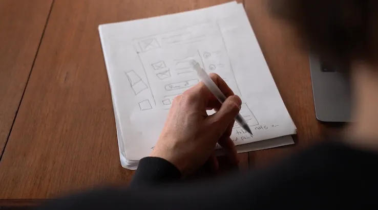 Person drawing on paper