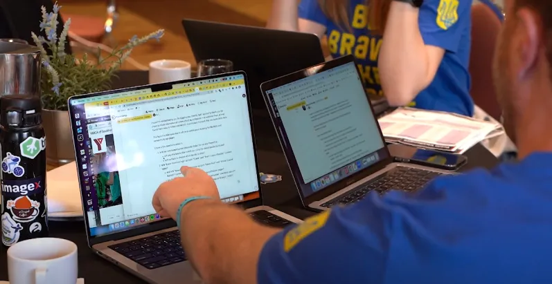 Person pointing at laptop