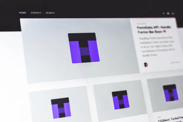 Close-up of a computer screen displaying a modern website interface with image thumbnails and navigation links.