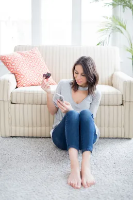 A lady sitting next to a sofa