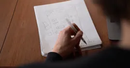 Person drawing on paper
