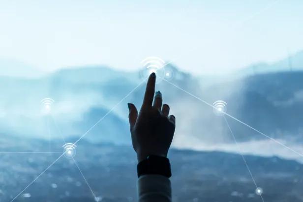 Hand pointing towards mountains