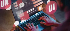 Person typing on laptop with floating icons