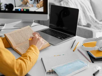 Student reading and studying on laptop