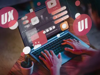 Person typing on laptop with floating icons
