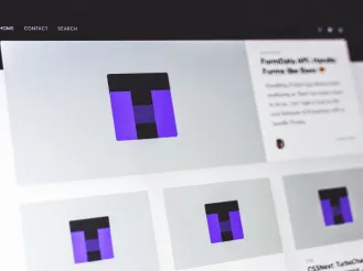 Close-up of a computer screen displaying a modern website interface with image thumbnails and navigation links.