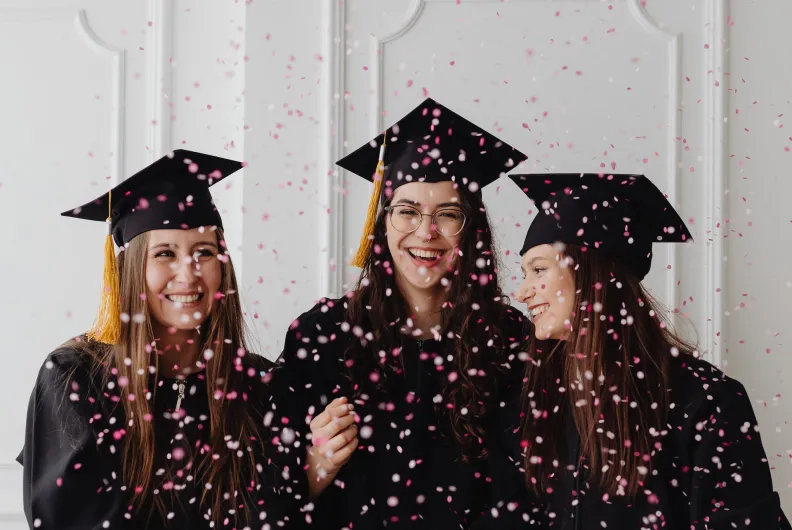 Graduating students with confetti