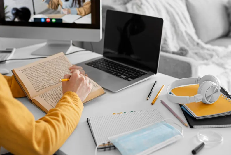 Student reading and studying on laptop