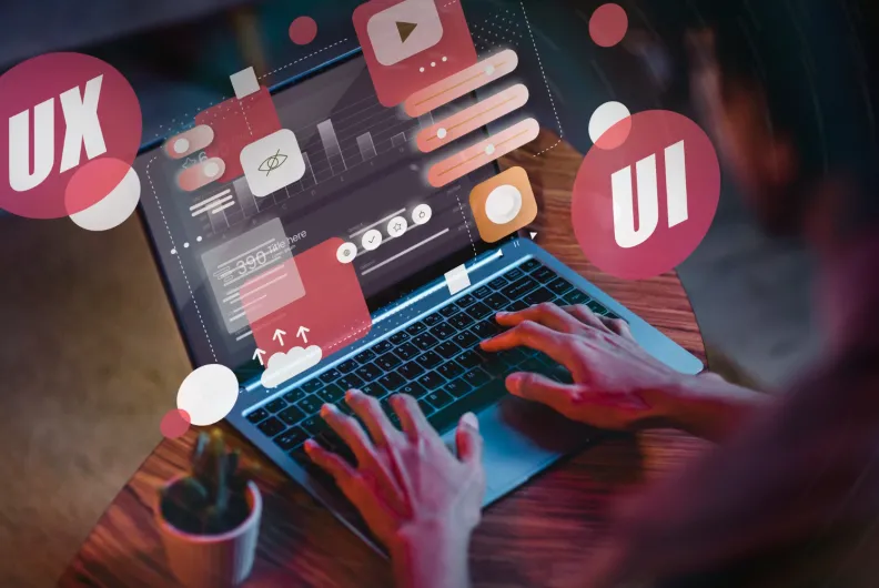 Person typing on laptop with floating icons