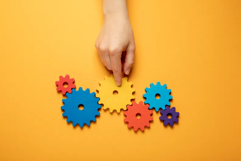 Finger pointing at spinning gears