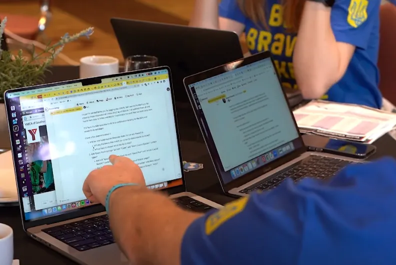 Person pointing at laptop