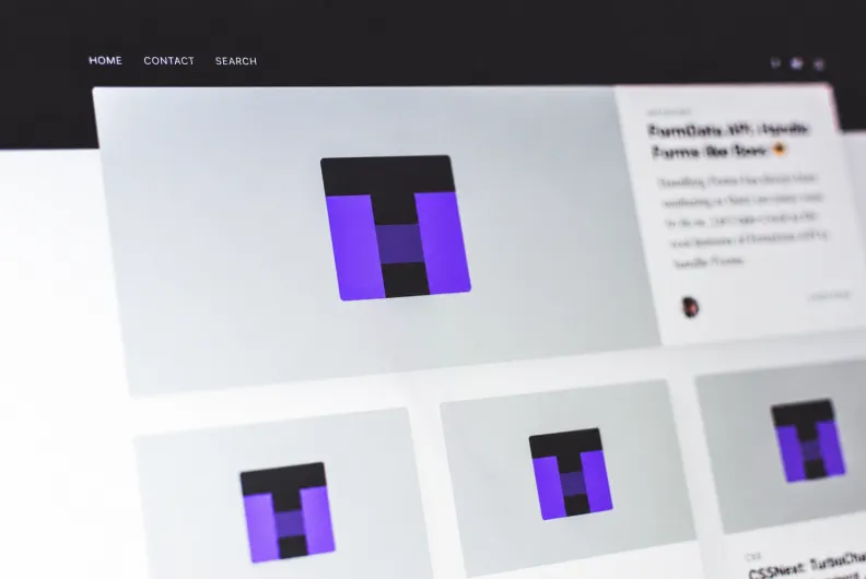 Close-up of a computer screen displaying a modern website interface with image thumbnails and navigation links.