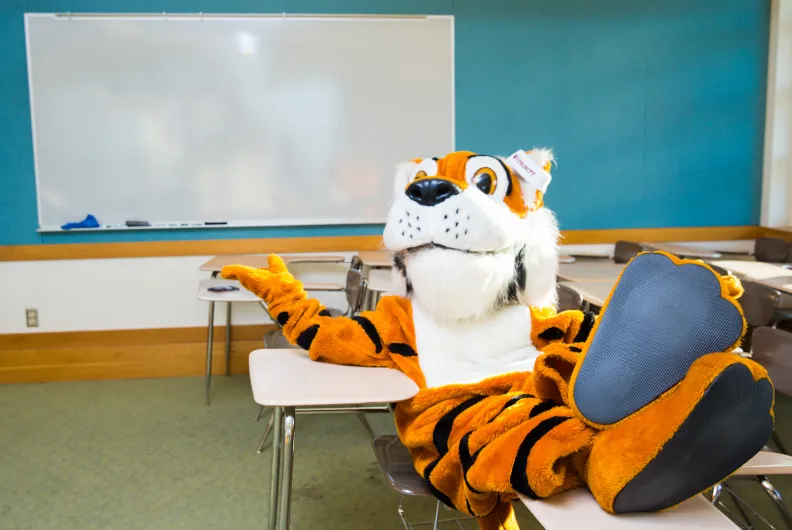 Trinity tiger mascot sitting in classroom