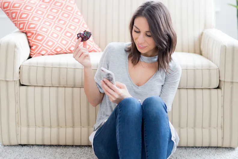 A lady sitting next to a sofa