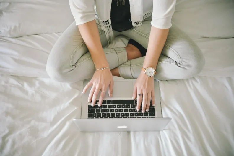 A person typing on her laptop